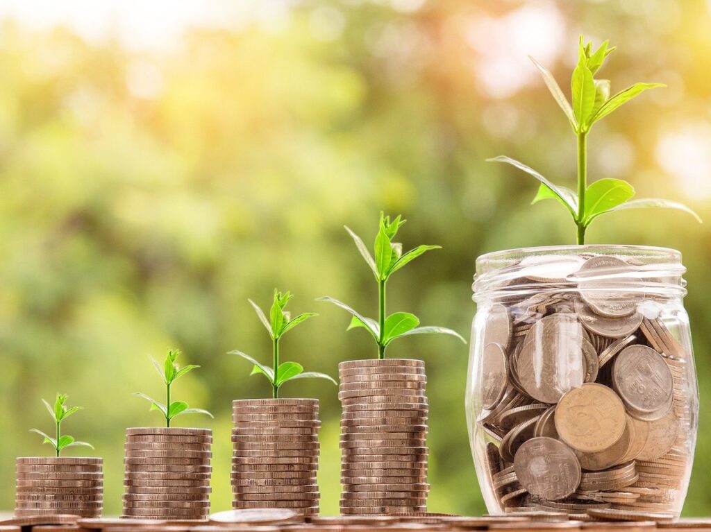 Stacks of coins with plants growing out of them